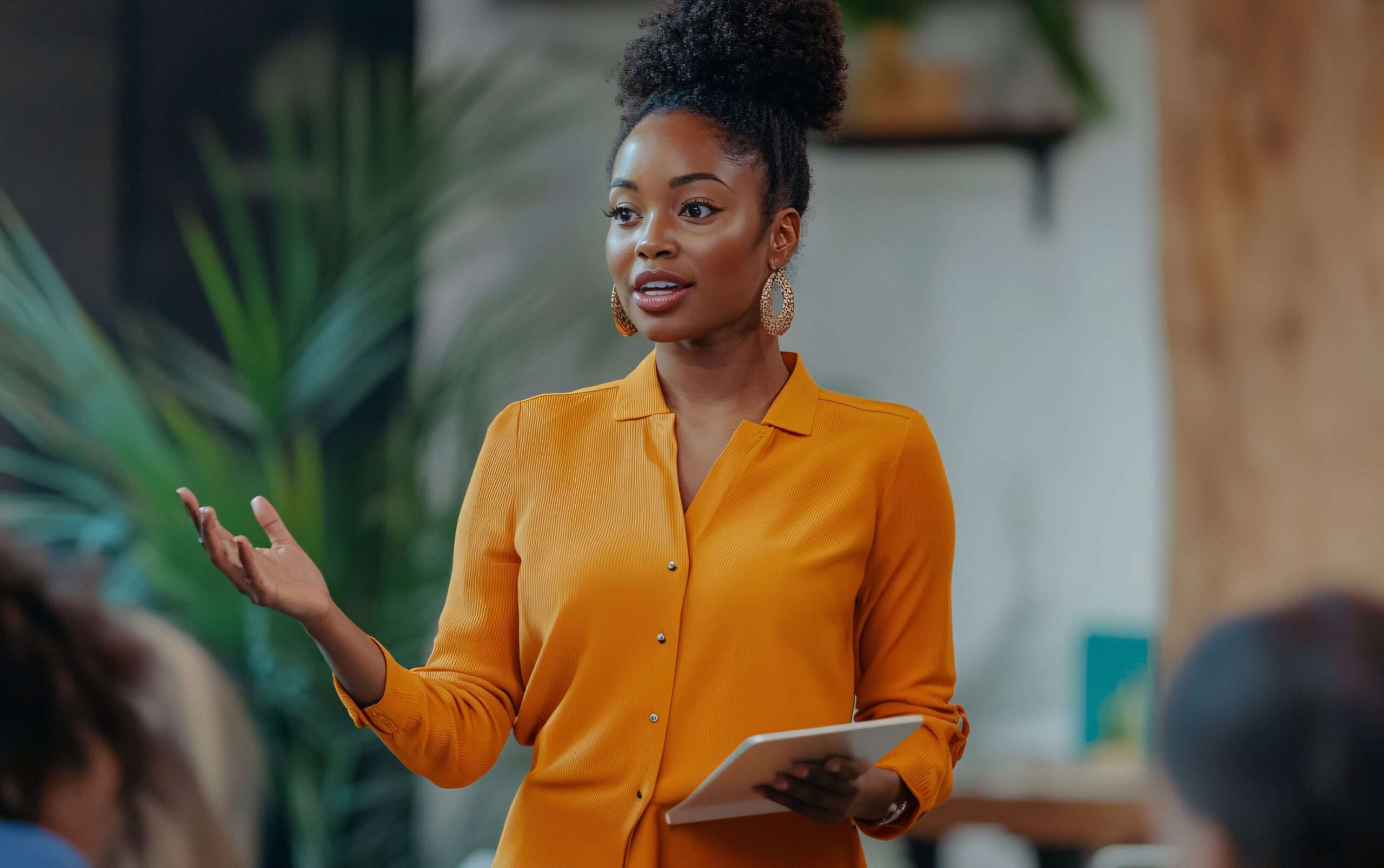 a woman holding a tablet and talking