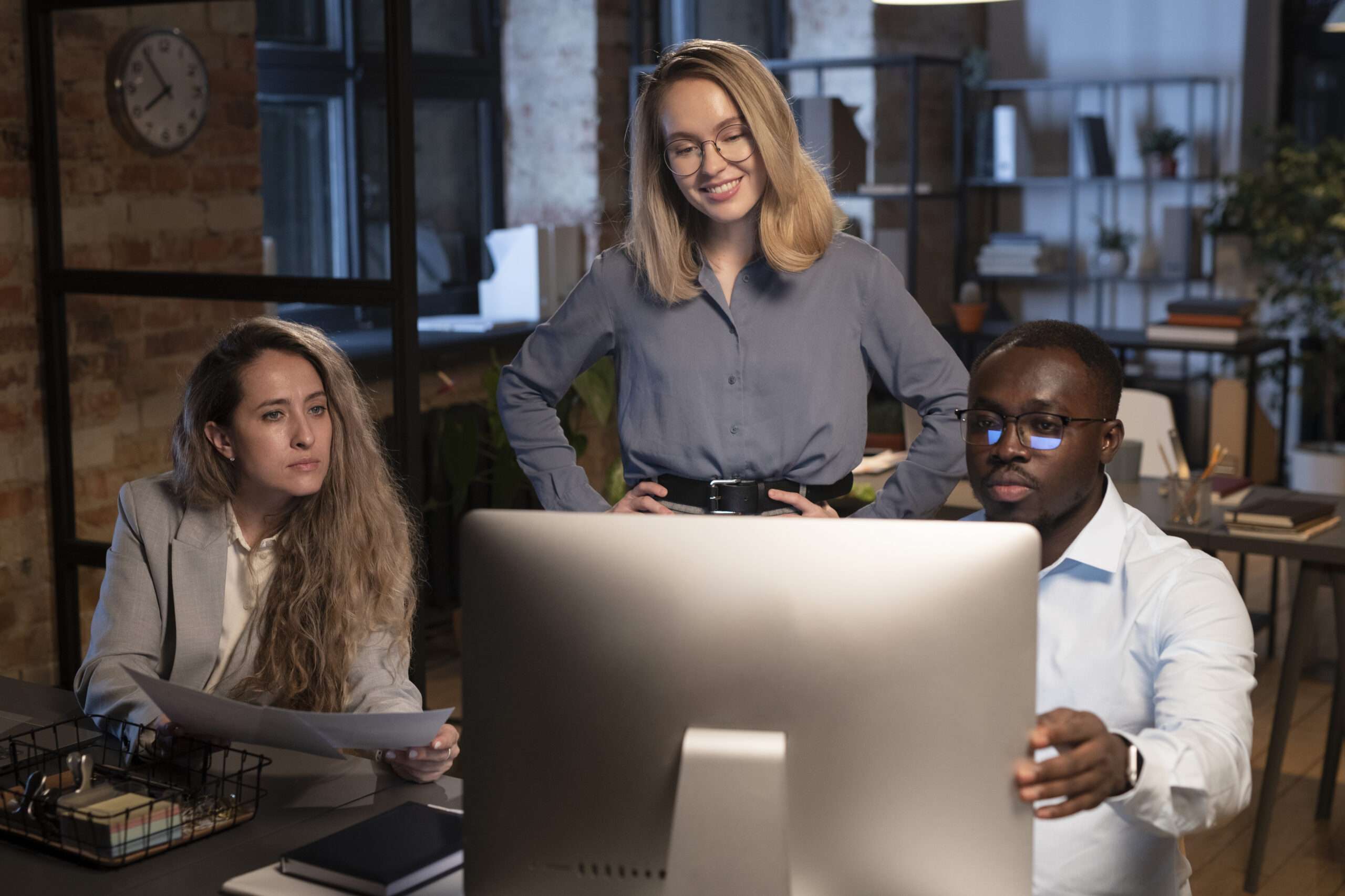 three coworkers looking monitor scaled